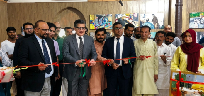 Prof. Dr. Aqif Anwar Chaudhry, Vice Chancellor of the University of Education, performs the ribbon-cutting ceremony to inaugurate the exhibition.